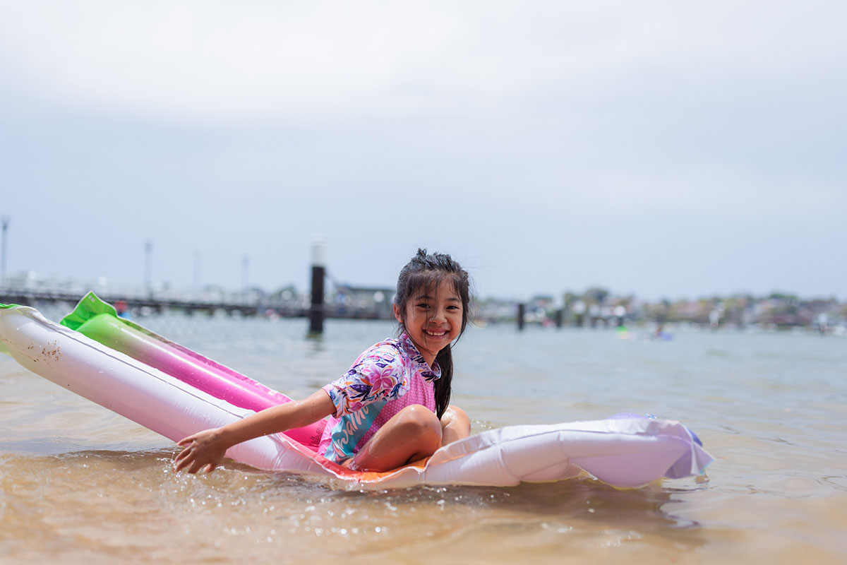 Girl on float at the beach at Bayview Baths.