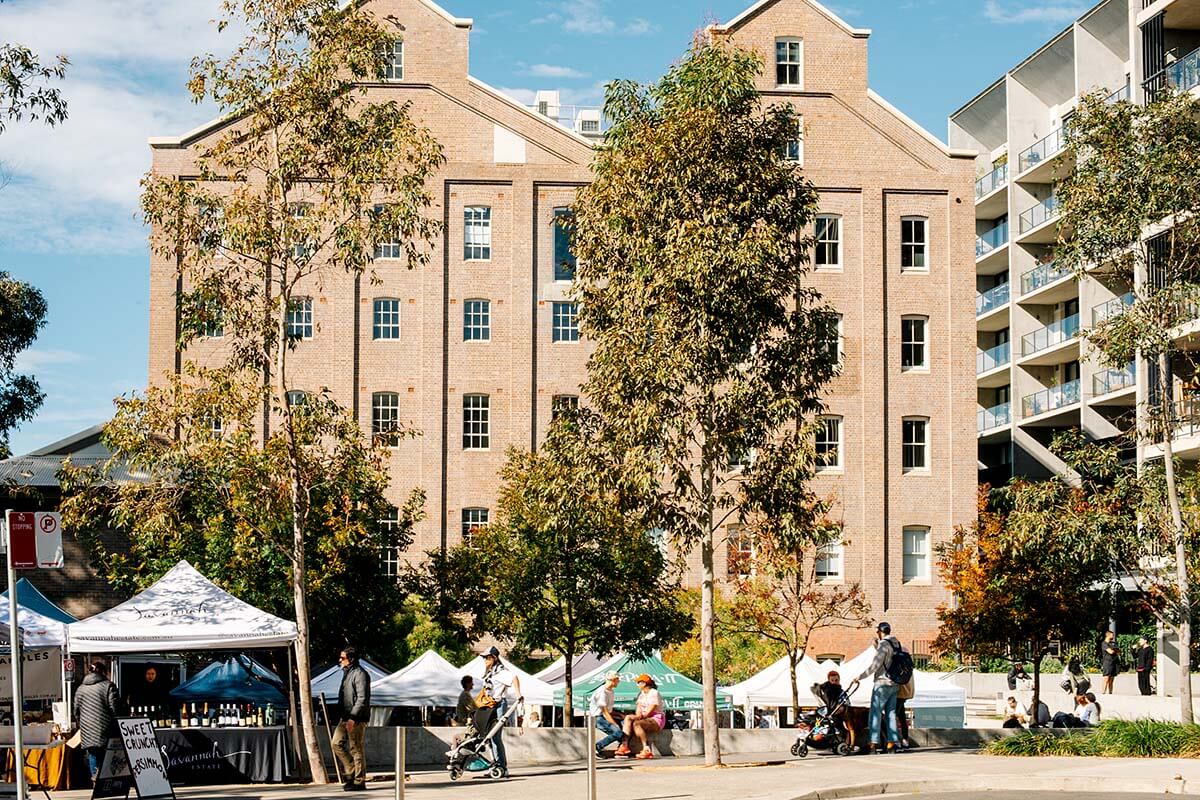 Stalls and people at Summer Hill Flour Mill Markets in Sydney's Inner West. Credit: Lisa Madden/DPHI
