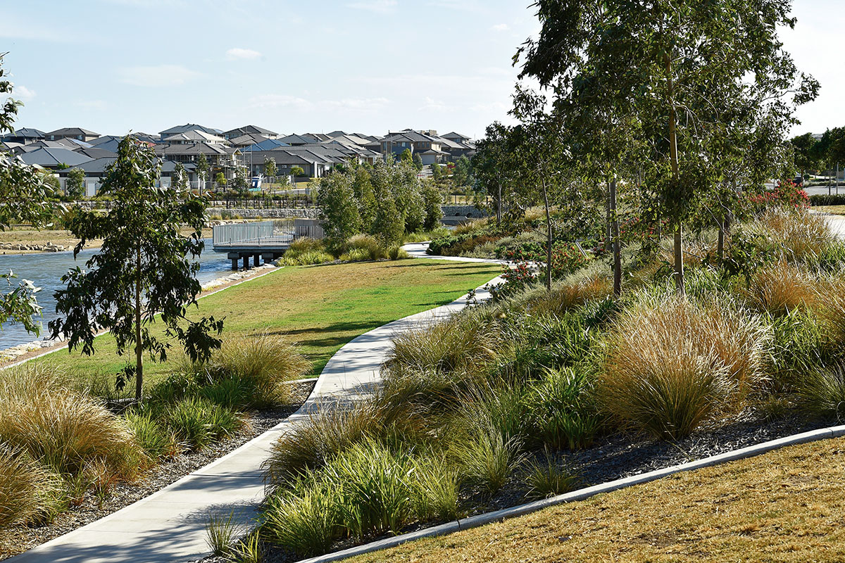 Pedestrian path in Grand Prix Park with housing in the background at Oran Park.
