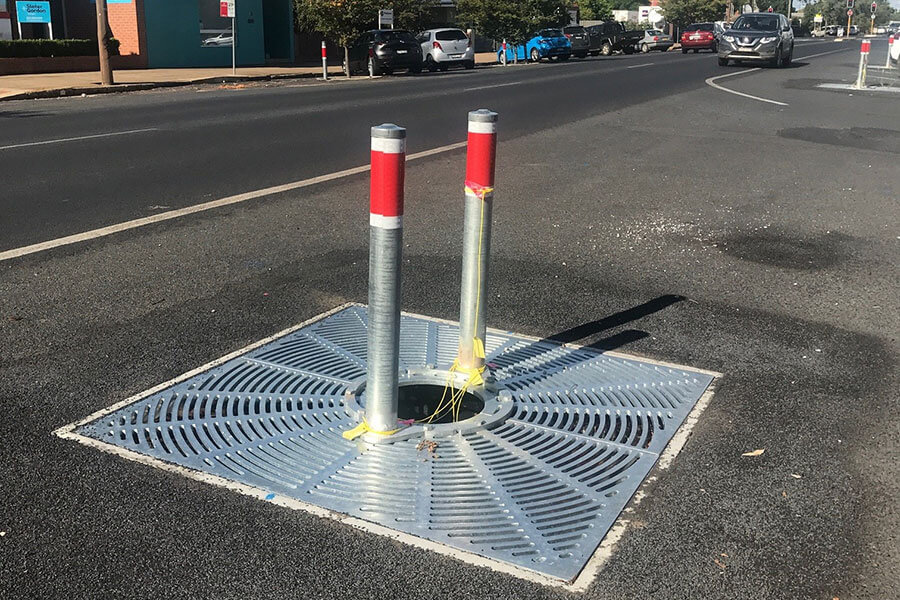 Urban design to capture stormwater runoff from nearby road that provides water for irrigating trees