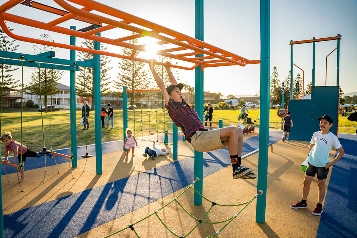 Children play on a playground at Reddall Reserve, Lake Illawarra. Credit: NSW Department of Planning and Environment