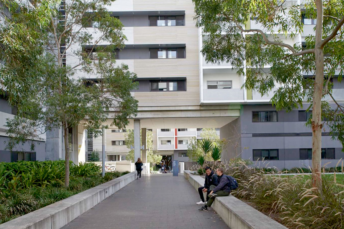 Two people sitting and socialising at the UNSW Village, a student accommodation location designed by Architectus. Credit: Andrew Cohen 2018