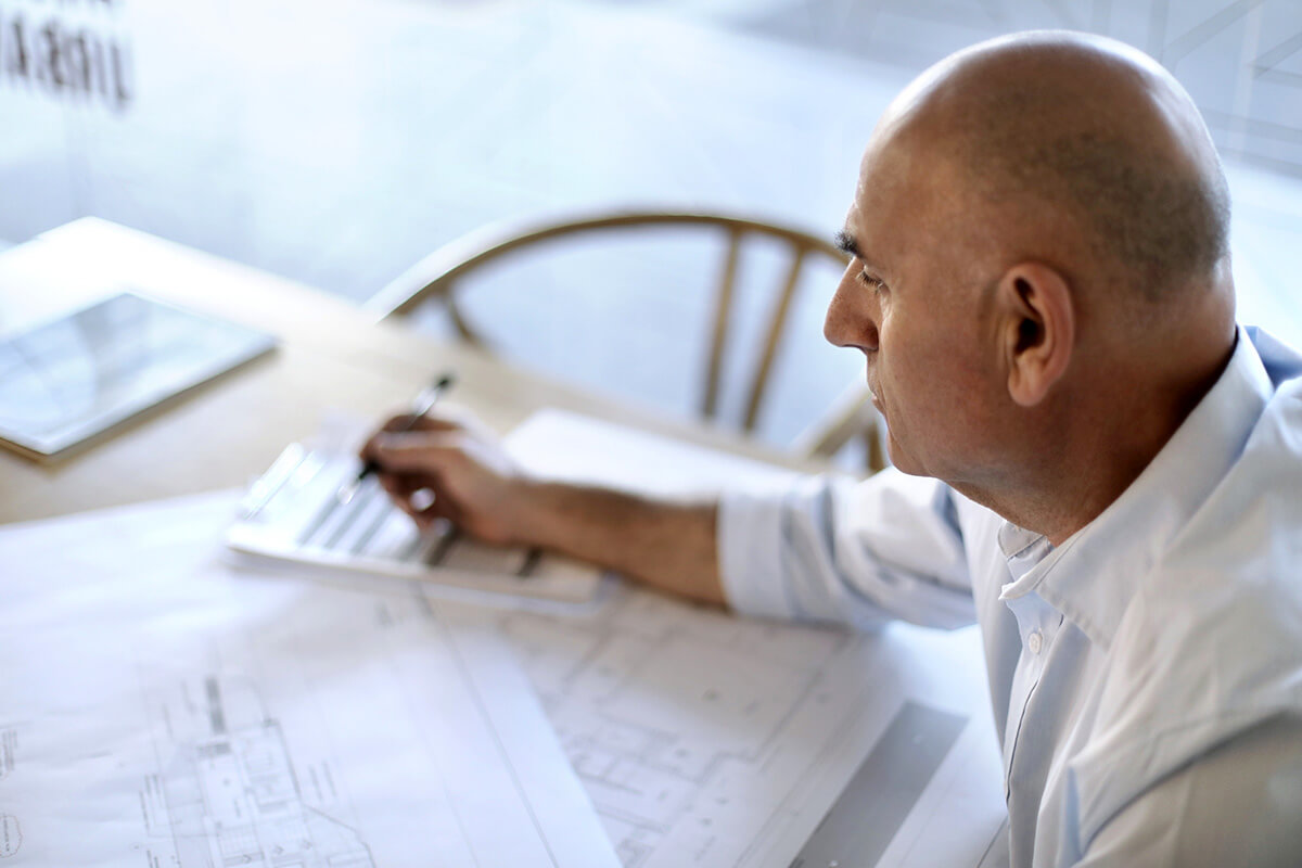 A male building certifier works from home, a benefit of flexible working conditions. Credit: NSW Department of Planning, Housing and Infrastructure / Christopher Walters